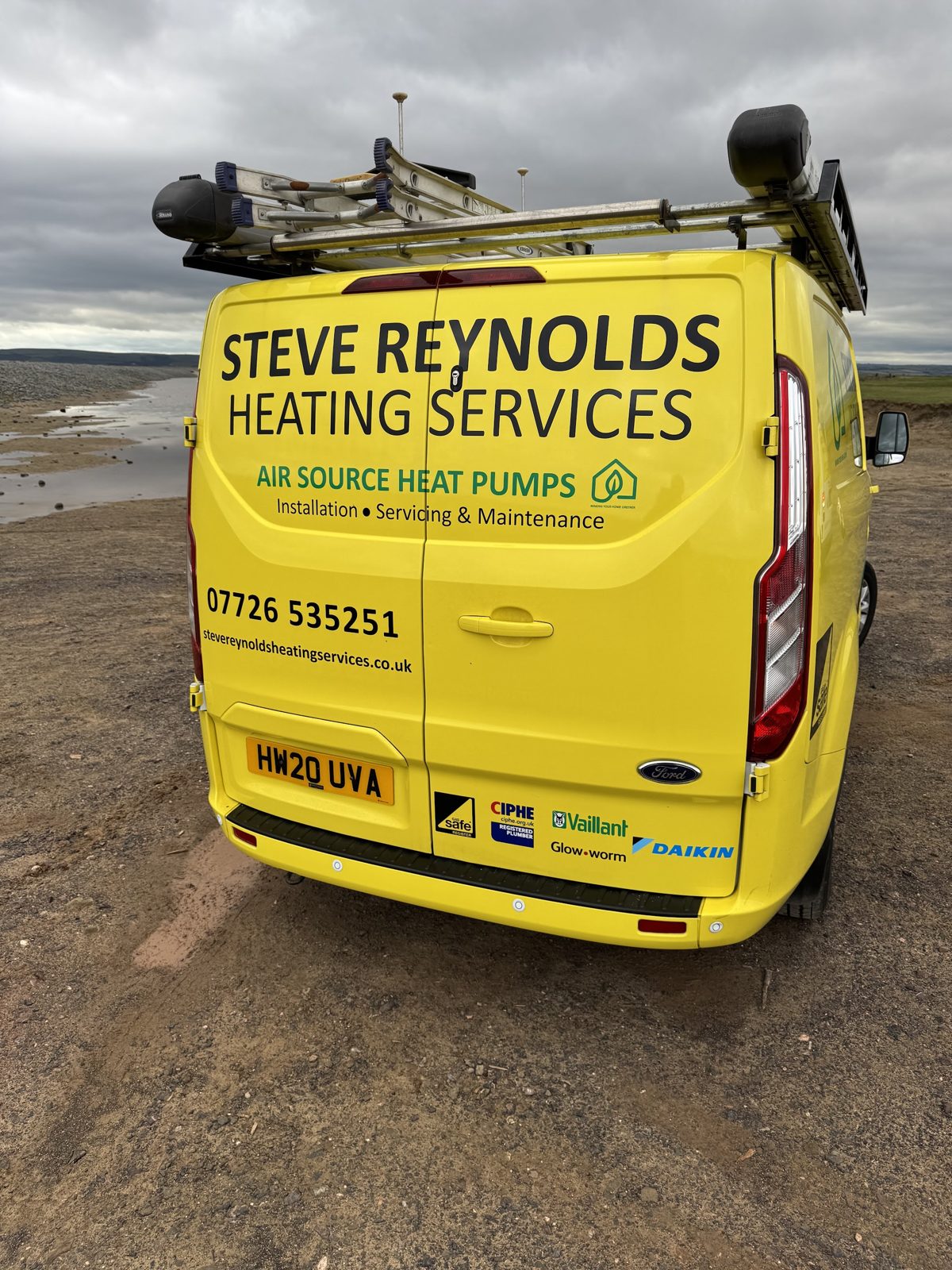 The back of the yellow Steve Reynolds van, lettered Air Source Heat Pumps, Installation, Servicing and Maintenance